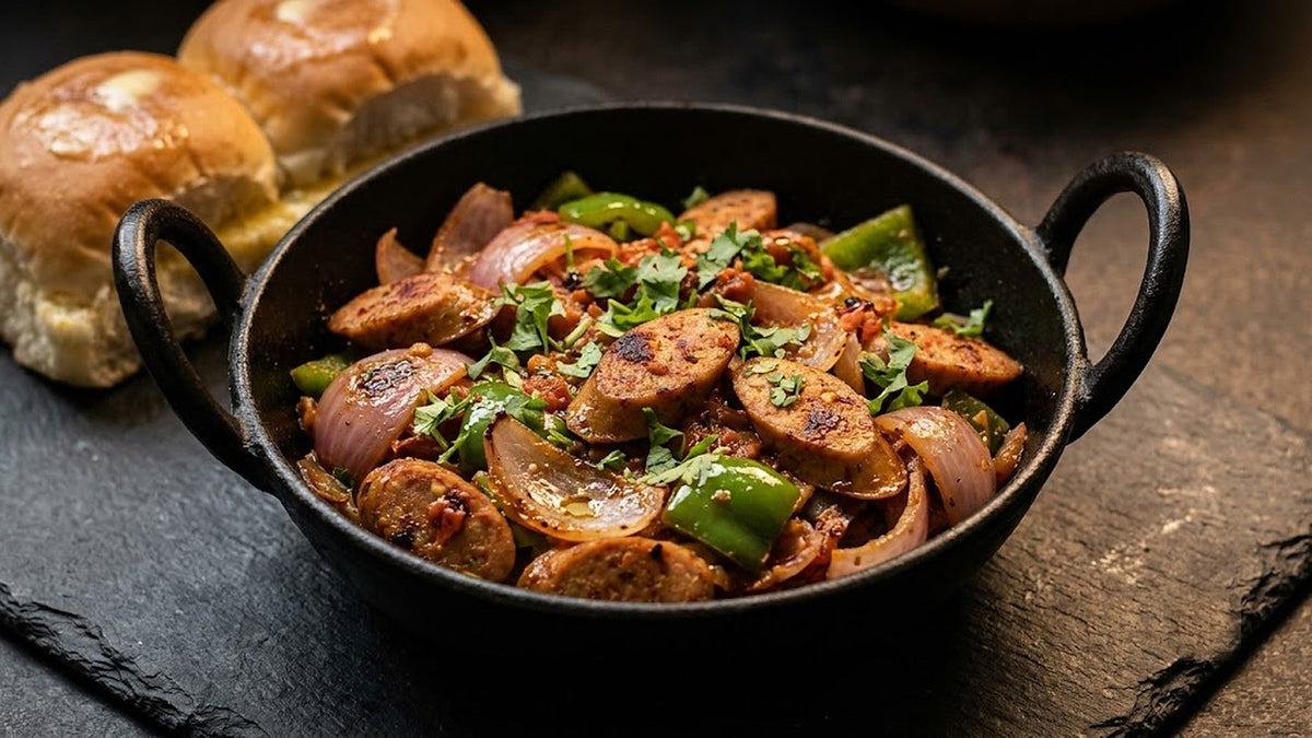 Indian chicken sausage masala with onions and capsicum in an iron kadai with pav, Fresh'N Frozen