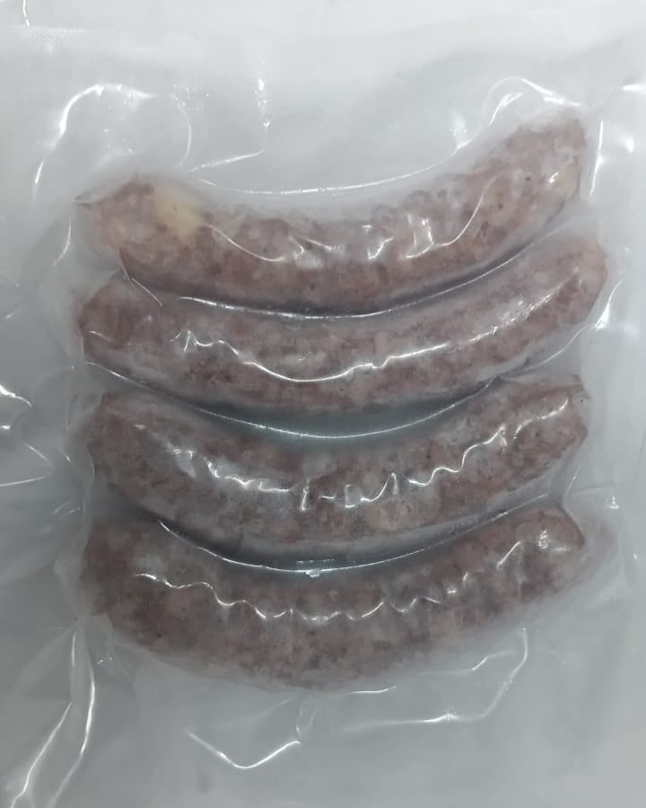 Three sausages in clear plastic packaging on a white background